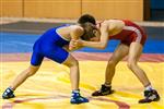 Boys grappling on wrestling mat