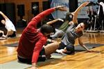 Men and women stretching in exercise room