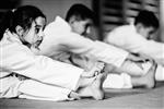 Coed youth students stretching in karate class