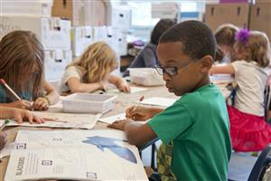 Young Boy Drawing in Class