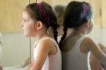 Young girl taking a break in ballet class.